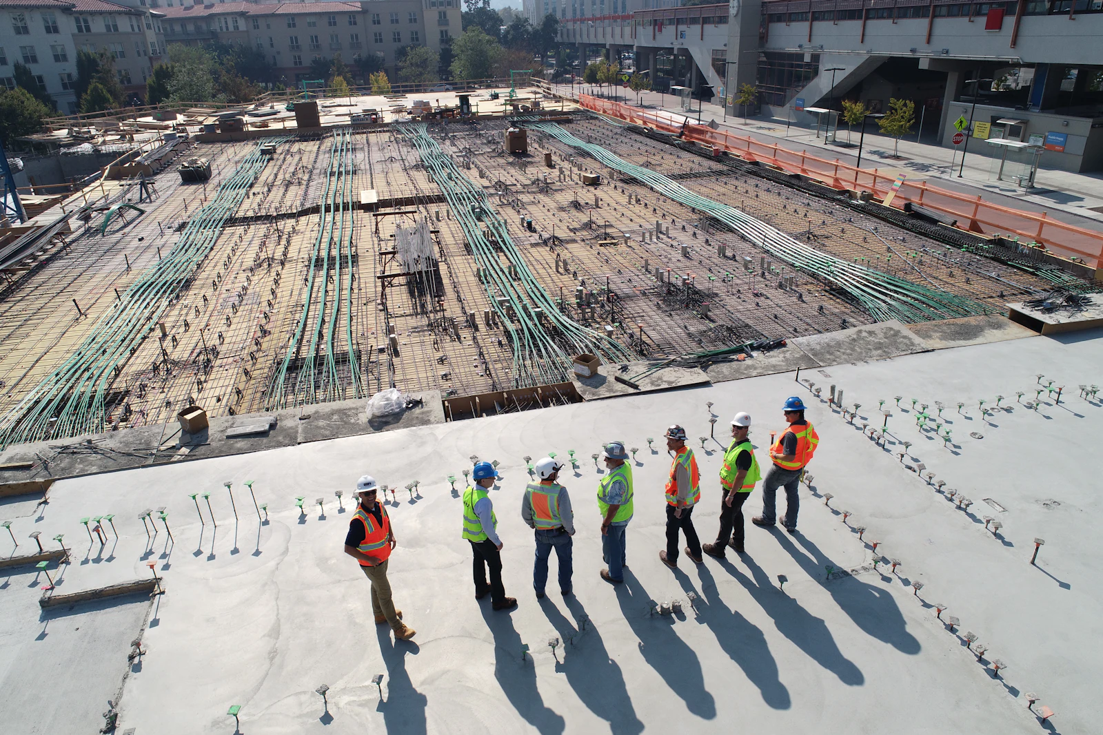 Contractors reviewing progress on a construction site slab